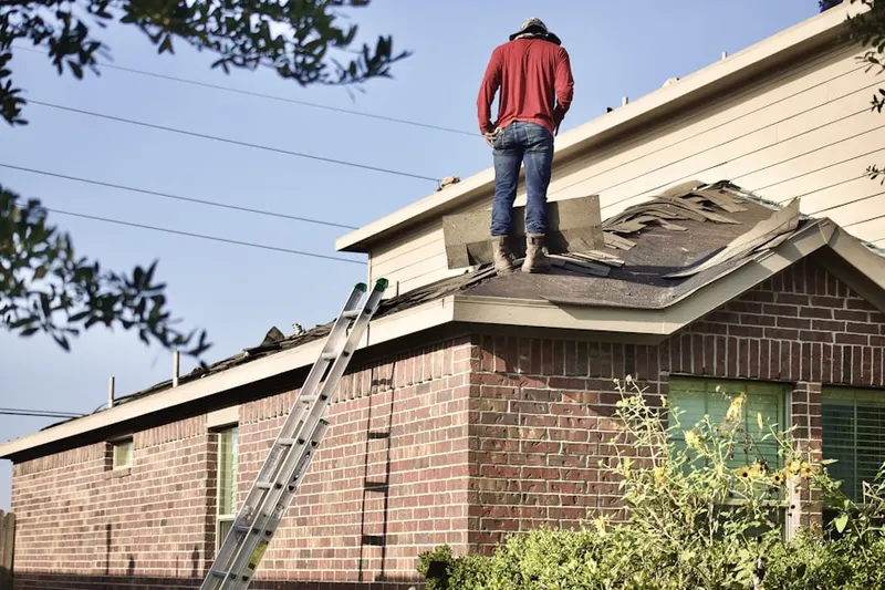 Professional roofer working on a residential roof in Pennhurst